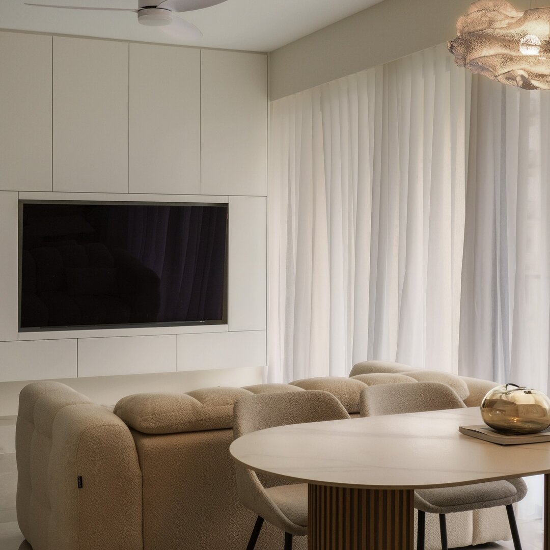 A taupe Son&Bear sofa and oval dining table in a bright customer apartment