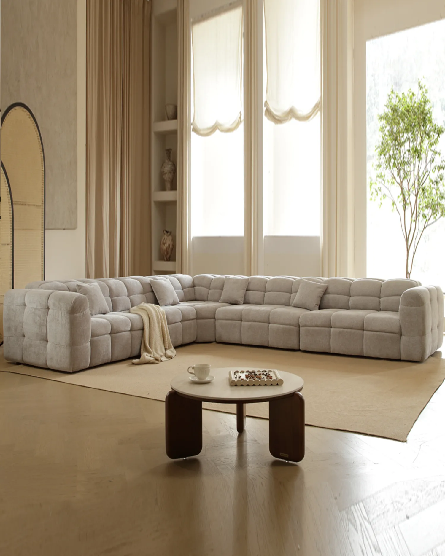 Klara L-Shaped sofa in golden evening light against a warm wood-panelled wall