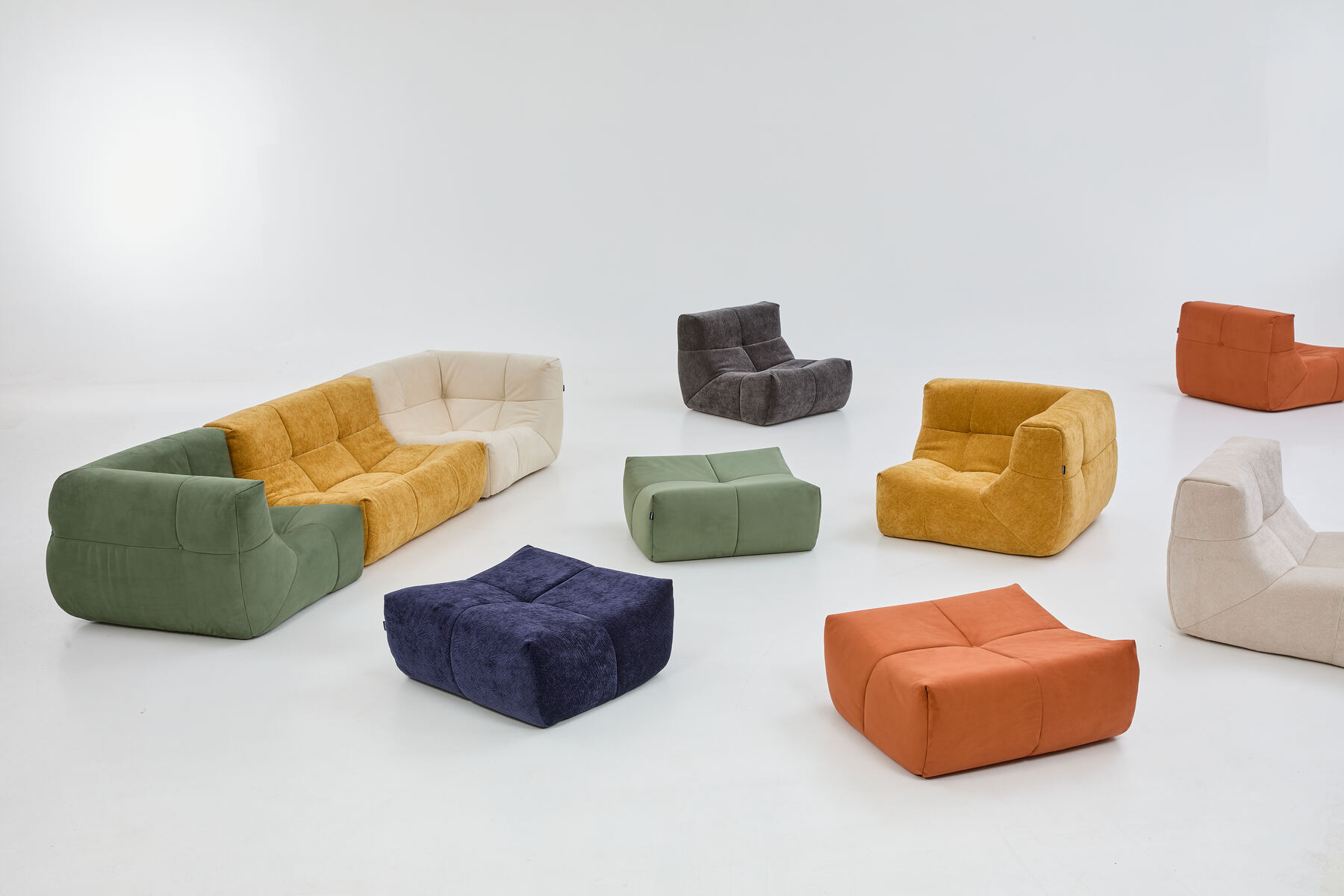 Milo modular sofa pieces in five colourways, separated to show how the modules mix and rearrange.