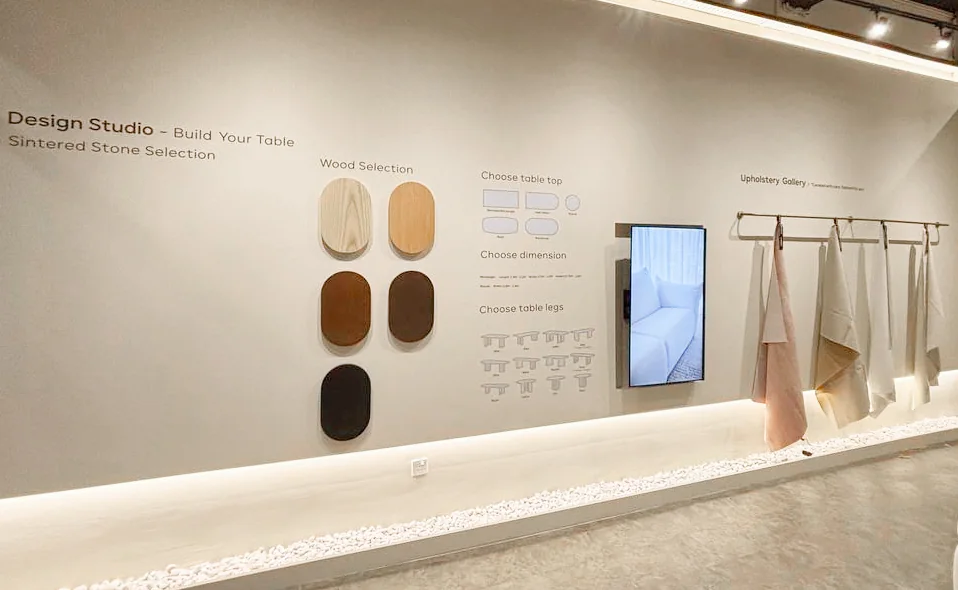 The Son&Bear Kuching showroom: the Design Studio wall, with the wood finishes, table shapes and upholstery fabrics to choose from.